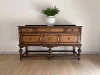 Vintage 1920s Berkey and Gay Sideboard Buffet Server Table - Jacobean Style The sideboard is supported by Baroque-style turned legs along the front with bun feet. It has a small backsplash on the backing.