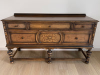 Vintage 1920s Berkey and Gay Sideboard Buffet Server Table - Jacobean Style The sideboard is supported by Baroque-style turned legs along the front with bun feet. It has a small backsplash on the backing.