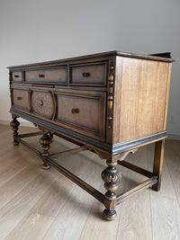 Vintage 1920s Berkey and Gay Sideboard Buffet Server Table - Jacobean Style The sideboard is supported by Baroque-style turned legs along the front with bun feet. It has a small backsplash on the backing.