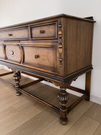 Vintage 1920s Berkey and Gay Sideboard Buffet Server Table - Jacobean Style The sideboard is supported by Baroque-style turned legs along the front with bun feet. It has a small backsplash on the backing.
