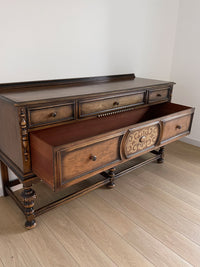 Vintage 1920s Berkey and Gay Sideboard Buffet Server Table - Jacobean Style The sideboard is supported by Baroque-style turned legs along the front with bun feet. It has a small backsplash on the backing.