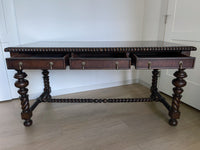 Vintage Portuguese Inspired Wood Barley Twist Writing Desk or Center Table An exceptional monumental Portuguese 1900s inspired barley twist writing desk, console, sofa or center table believed to be from the late 20th century or post 1960s to 1990s. There is not a tag or stamp. Baroque or Jacobean revival style with three smooth sliding drawers. The drawer has a pen holder in the center drawer.