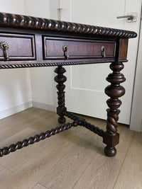 Vintage Portuguese Inspired Wood Barley Twist Writing Desk or Center Table An exceptional monumental Portuguese 1900s inspired barley twist writing desk, console, sofa or center table believed to be from the late 20th century or post 1960s to 1990s. There is not a tag or stamp. Baroque or Jacobean revival style with three smooth sliding drawers. The drawer has a pen holder in the center drawer.