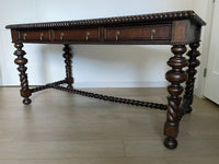 Vintage Portuguese Inspired Wood Barley Twist Writing Desk or Center Table An exceptional monumental Portuguese 1900s inspired barley twist writing desk, console, sofa or center table believed to be from the late 20th century or post 1960s to 1990s. There is not a tag or stamp. Baroque or Jacobean revival style with three smooth sliding drawers. The drawer has a pen holder in the center drawer.