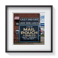A restored rustic advertisement for chew Mail Pouch Tobacco on an old brick building in the midwest of America. Fine americana and street art photography by Andrew Grant.  Framed wall art for your home, office, business, restaurant, bar, vacation house or hotel.