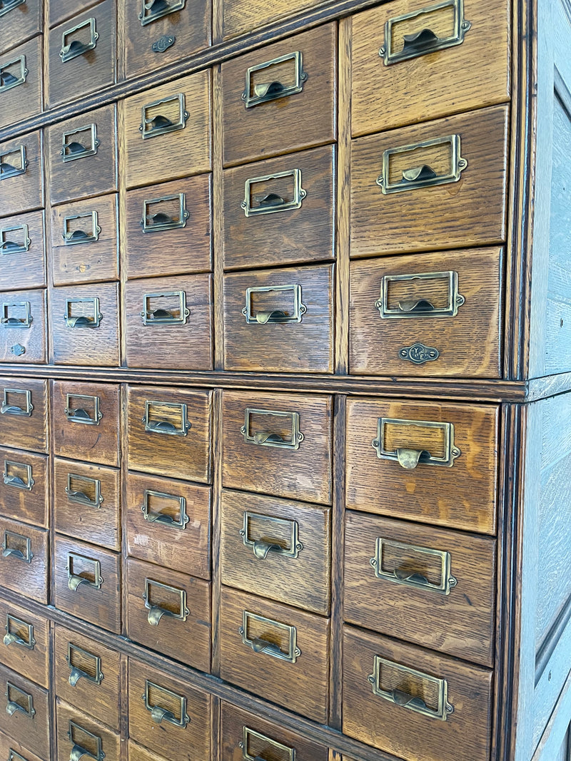 Antique 1900s Yawman Erbe 60 Drawer Library Card Catalog - Quarter Sawn Tiger Oak Industrial Stacking Architectural Cabinet YAWMAN AND ERBE MFG. CO. Rochester, N.Y. U.S.A. file cabinet. c1900s. This rare and beautiful quarter sawn tiger oak card catalog, apothecary, haberdashery or architectural cabinet storage piece would make a perfect statement piece for your bar, wine storage, entryway, foyer, dining room, office or commercial space! 