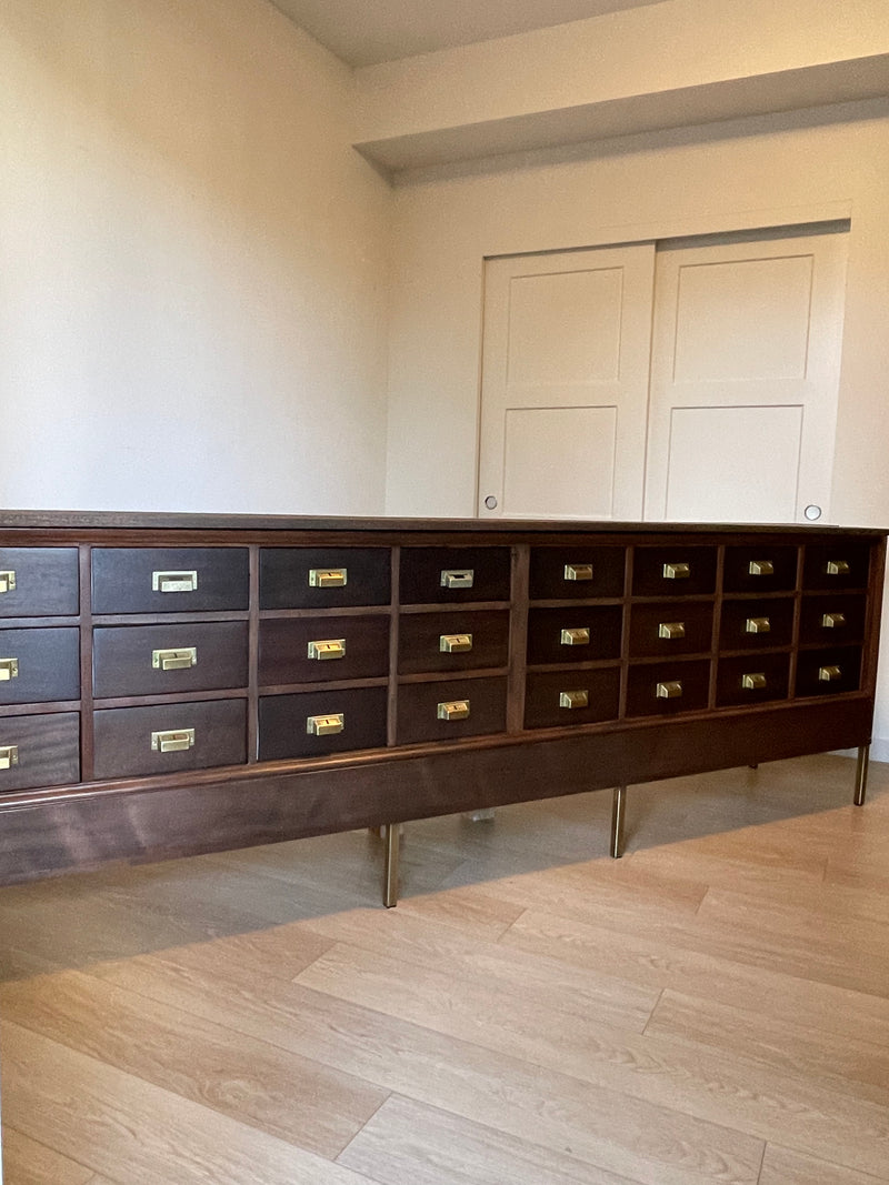 Antique 9 Foot, Mahogany Credenza Lateral 24 Drawer Haberdashery Solid Wood Cabinet - Circa 1920s. A versatile large scale cabinet ideally suited in a retail environment, hotel, library, bourbon bar, an oversized sofa table or office space.