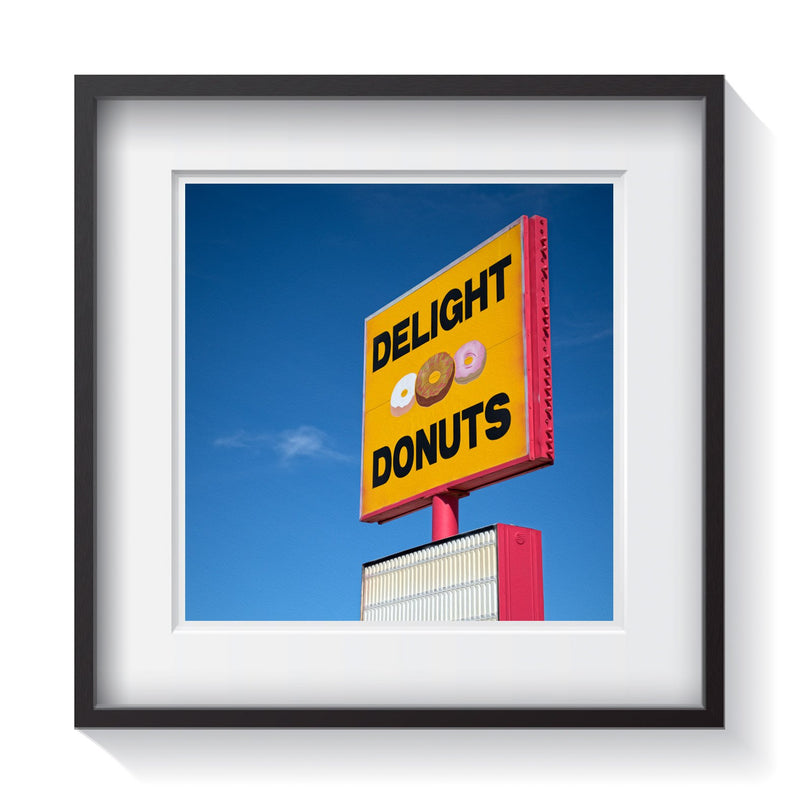 A vintage bright yellow and red sign for Delight Donuts along the American roadside. Framed fine Americana and vintage sign photography by Andrew Grant.  Framed wall art for your home, office, business, restaurant, bar, vacation house or hotel.