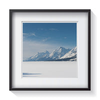 A shadow pointing to the Grand Teton Mountain range on a frozen and snow covered Jackson Lake. Framed fine art landscape photography by Andrew Grant.   Framed wall art for your home, office, business, restaurant, bar, vacation house or hotel.