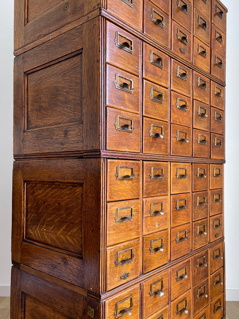 Antique 1900s Yawman Erbe 60 Drawer Library Card Catalog - Quarter Sawn Tiger Oak Industrial Stacking Architectural Cabinet YAWMAN AND ERBE MFG. CO. Rochester, N.Y. U.S.A. file cabinet. c1900s. This rare and beautiful quarter sawn tiger oak card catalog, apothecary, haberdashery or architectural cabinet storage piece would make a perfect statement piece for your bar, wine storage, entryway, foyer, dining room, office or commercial space! 
